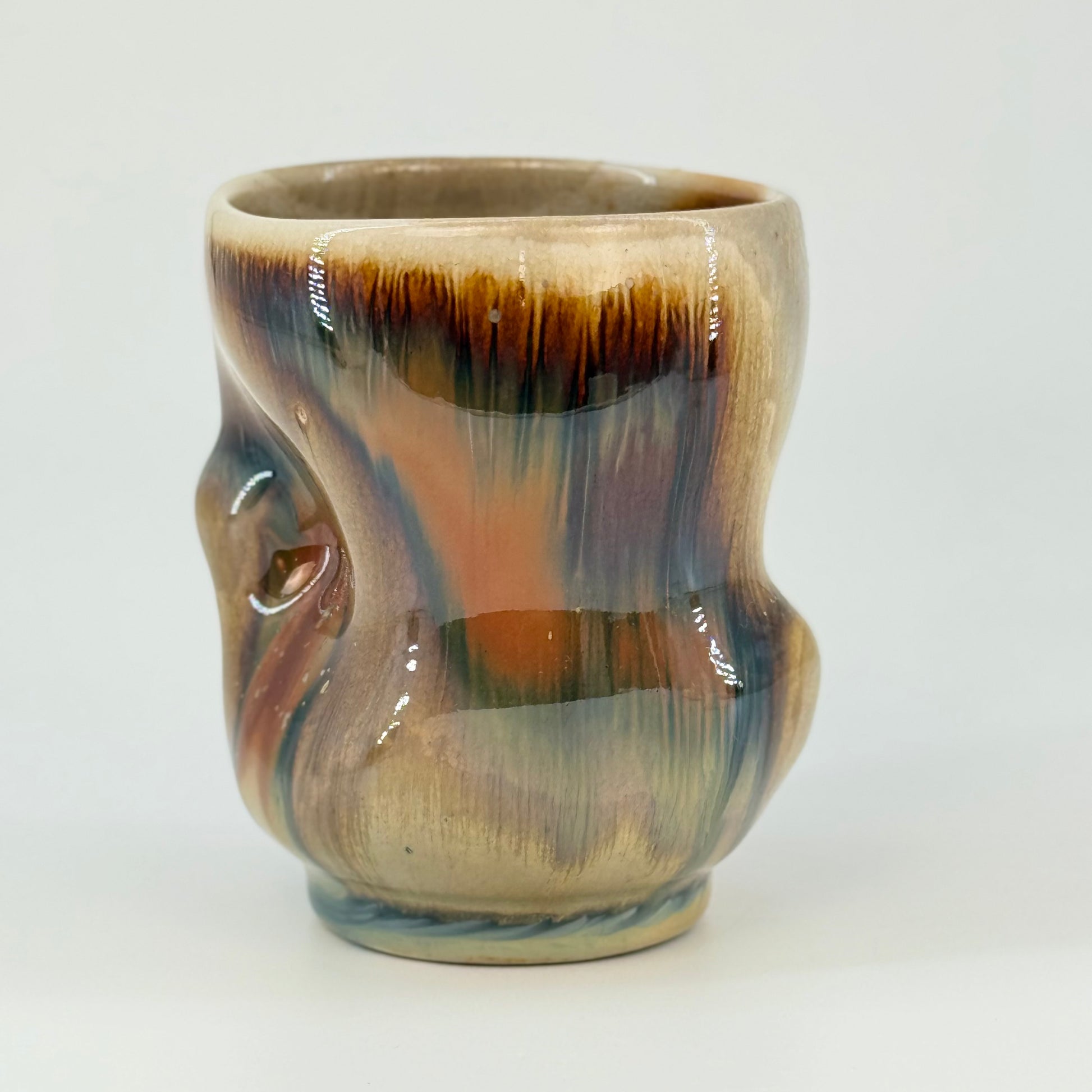 Ceramic Cup with multicolored glaze on a white background
